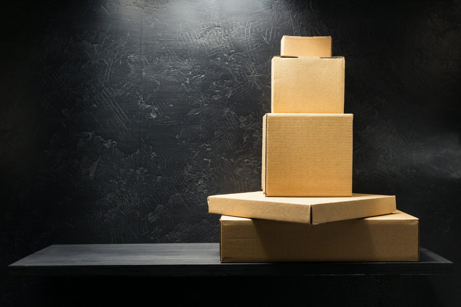 cardboard box on wooden shelf