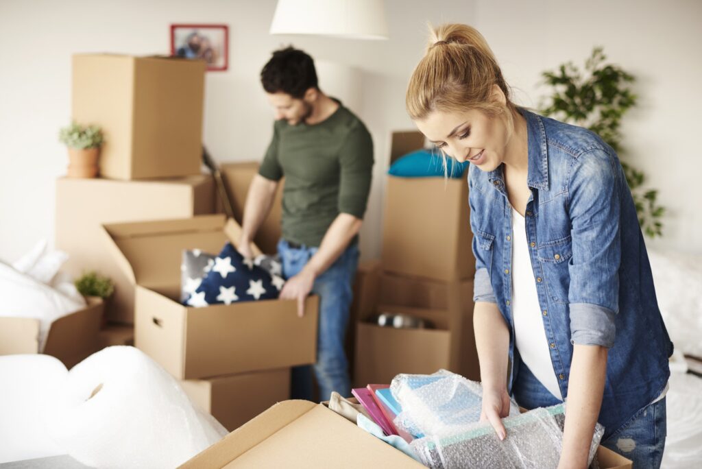 Waist up of moving house couple